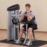 Man using Body-Solid Series II Arm Curl Machine for strength training with heavy-gauge steel frame.